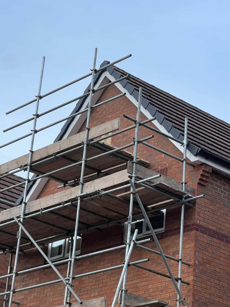 This is a photo of a roof which has just been repaired. There is a scaffold located at the gable end for access onto the roof. Works carried out by Burgess Hill Roofing Repairs